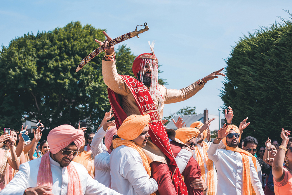 The Baraat: The Groom’s procession, as his entire family and friends lead him to the altar. (Christopher Brock Photography)